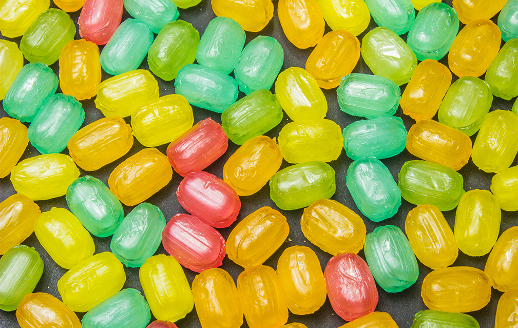 FoodRGB Natural food color application photography for confectionery hard candy in red, orange, yellow, green.