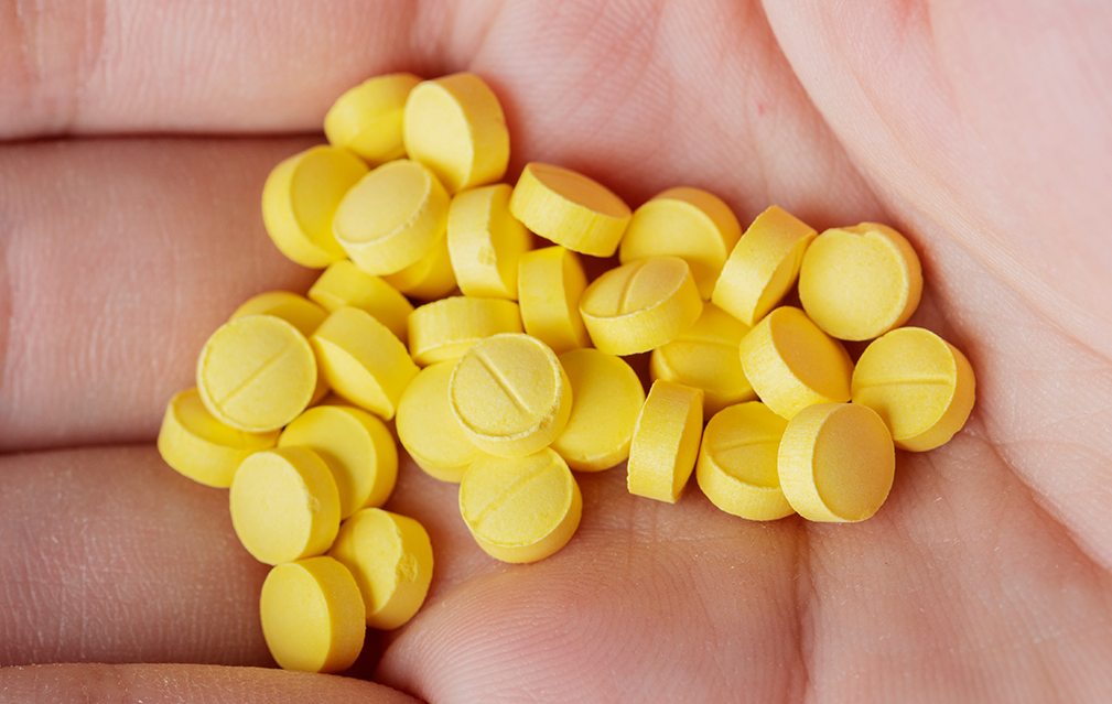 FoodRGB Natural food color application photography for nutraceuticals coated pills with yellow natural food color